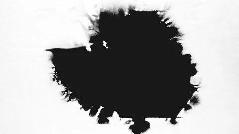 Spraying black paint on a white background Stock Footage 303171828