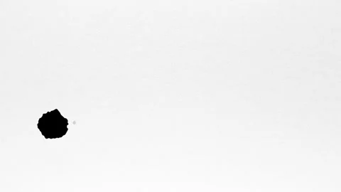 Spraying black paint on a white background Stock Footage 303171836