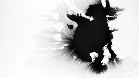Spraying black paint on a white background Stock Footage 303171854