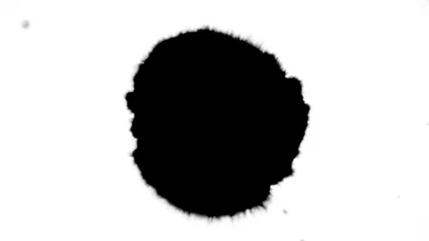 Spraying black paint on a white background Stock Footage 303171924
