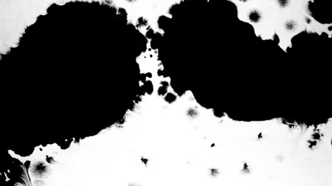 Spraying black paint on a white background Stock Footage 303171956