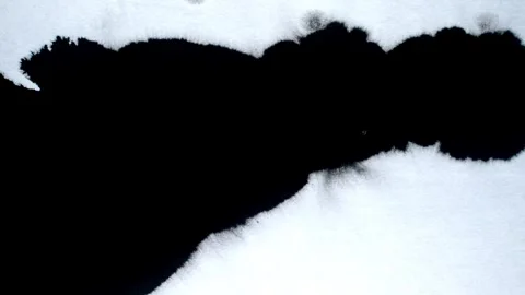 Spraying black paint on a white background Stock Footage 303171980
