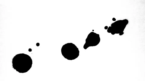 Spraying black paint on a white background Video stock 303171981