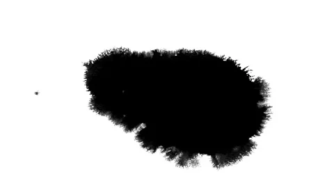 Spraying black paint on a white background Stock Footage 305492620