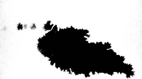 Spraying black paint on a white background Stock Footage 305493037