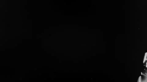 Spraying black paint on a white background Stock Footage 305493176
