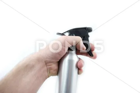 Spraying bottle in hand. isolated on white. Stock Photos