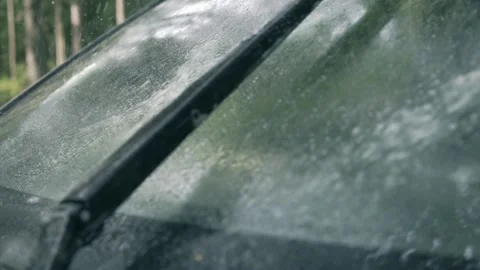 Spraying car windshield washer fluid slow motion, working wipers Stock-Footage 157327546