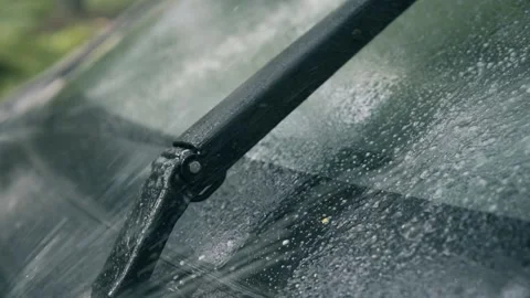 Spraying car windshield washer fluid slow motion, working wipers 動画素材 157327558