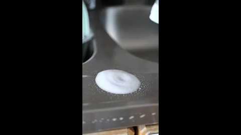 Spraying cleaner on a kitchen sink and wiping it clean in slow motion Stock Footage 332055009