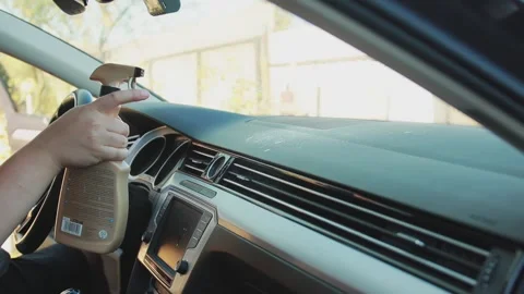 Spraying a cleaning agent onto the car panel inside the interior. Cleaning and Stock Footage 255634315