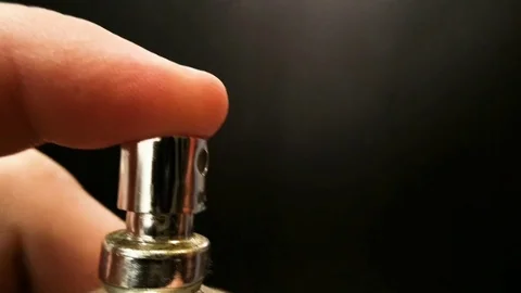 Spraying Cologne from a bottle closeup on dark background Stock-Footage 73873525