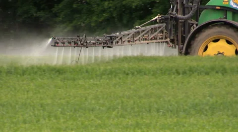 Spraying crops field with tractor and sprayer, farming, harvest Stock Footage 40764161