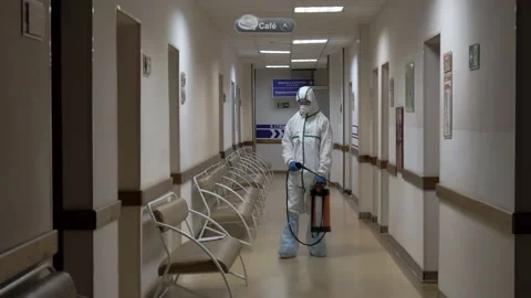 Spraying a disinfectant solution in the corridor of the clinic Stock Footage 131460934