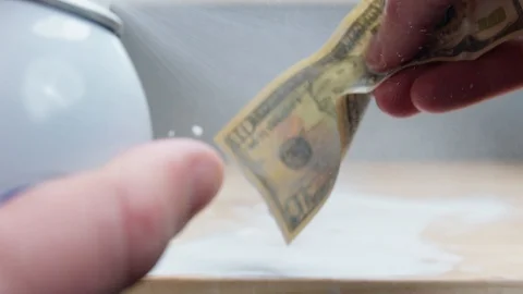 Spraying Down American Ten Dollar Bill US Currency Sanitary Spray Slow Motion Stock Footage 128932416