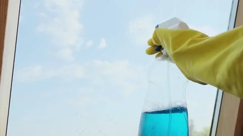 Spraying eco-friendly window cleaner, cleaning with cloth and spray. Gloved hand Stock Footage 301307492