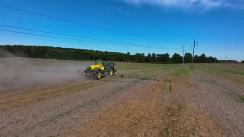 Spraying field. John Deere Tractor use spray and irrigation. Stock Footage 211458923