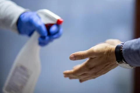 Spraying hands with antiseptic solution Stock Photos