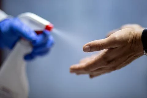 Spraying hands with antiseptic solution Stock Photos