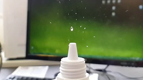 Spraying liquid into the air in laboratory. Drops in slow-motion Video stock 103656859