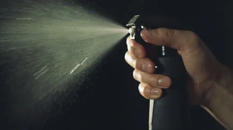 Spraying liquid from atomizer in dark room Видео 67315775