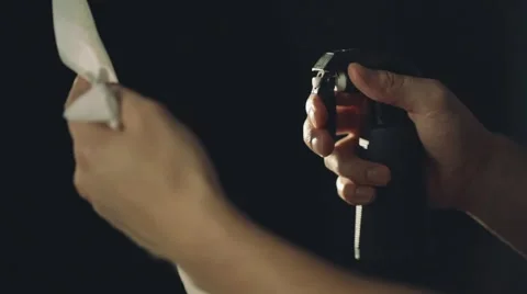 Spraying liquid from atomizer in dark room, such as barbershop Stock Footage 67315798