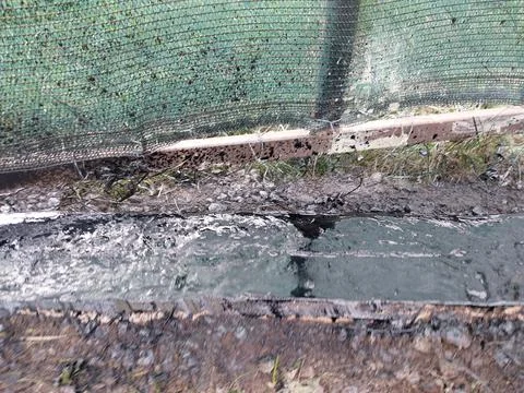 Spraying liquid bituminous mastic on the concrete foundation for insulation Stock Photos