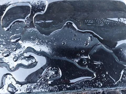 Spraying liquid bituminous mastic on the concrete foundation for insulation 库存照片