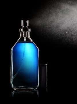 Spraying perfume bottle Stock Photos
