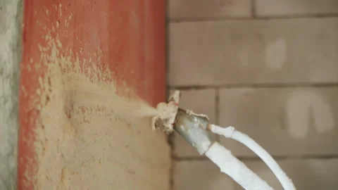 Spraying plaster on the wall with a gun Stock Footage 292660558