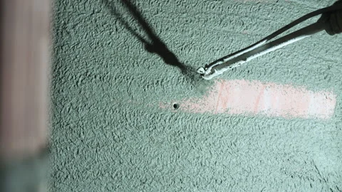Spraying plaster on wall using pneumatic device Stock Footage 311881592