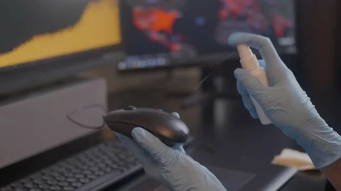 Spraying sanitizer to clean PC mouse,using glowes. Covid-19 disinfection concept Stock Footage 146221112