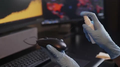 Spraying sanitizer to clean PC mouse,using glowes. Covid-19 disinfection concept Stock Footage 151676687