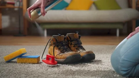 Spraying shoes with a protective moisture-proof spray Stock Footage 144808378
