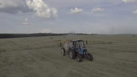 Spraying tractor working in fields Stock Footage 201611049