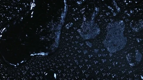 Spraying water on black background in slow motion Vídeo Stock 77761194