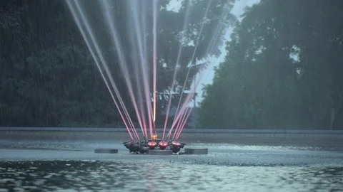 Spraying water in a evening park, background. Functioning decorative fountain in Video stock 198991846