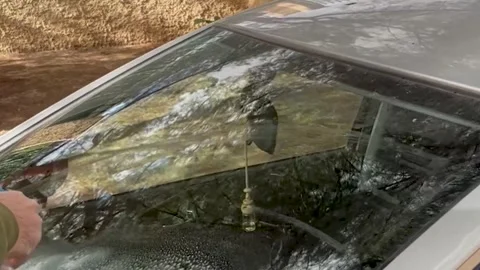 Spraying window cleaning product on a car windshield, car maintenance Stock Footage 262532599