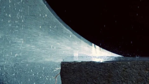Sprays in slow motion fly from under a circular saw cutting a stone block Stock Footage 76942421