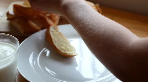 Spread Bread with Butter and Drinking Milk. Breakfast. Stock Footage 45508171