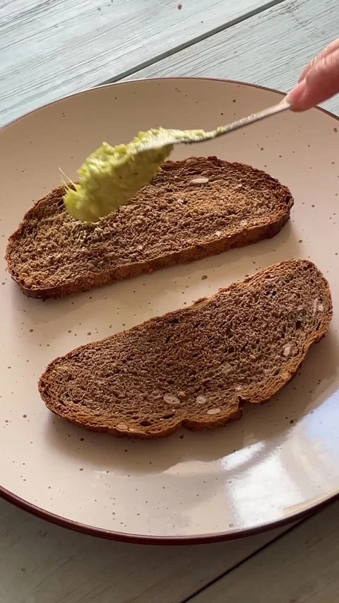 Spread bread with mashed avocado. Stock Footage 287860536