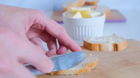 Spread butter on bread Stock Footage 285419782