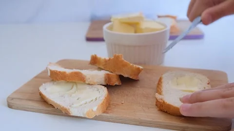 Spread butter on bread Stock Footage 285419783