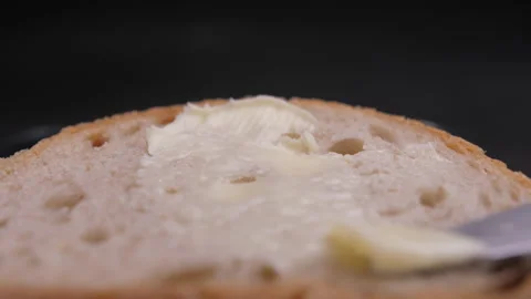 Spread butter on bread with knife slow motion 4k Stock-Footage 148325350