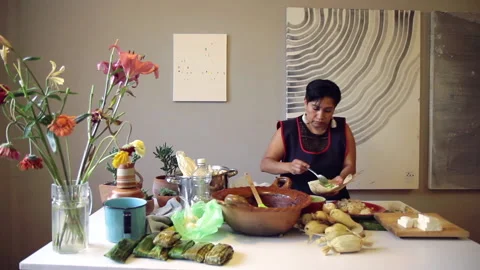 Spread corn dough on totomoxtle leave for tamales 47 Stock Footage 135782803