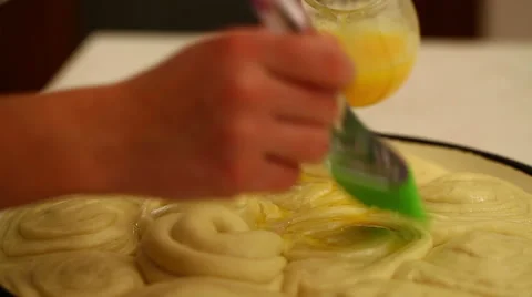 Spread with egg glaze on bread Stock Footage 54430214