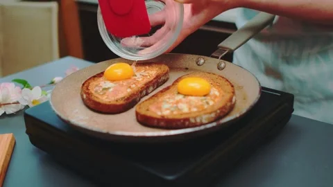 Spread the egg yolk on top of the fried toast Stock Footage 252403012