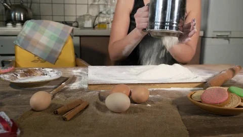 Spread the flour through a sieve on the dough Stock Footage 75343248
