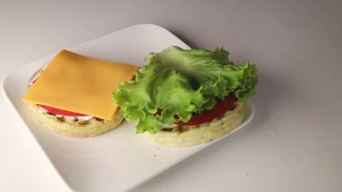 Spread a fresh lettuce leaf on the waffle. A beautiful burger Video stock 294564504