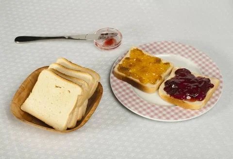 Spread jam on bread Spread jam on bread. Pink checkered plate ,model relea... Stock Photos